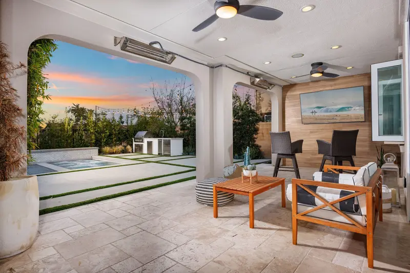 Covered loggia seating with outdoor kitchen at dusk — Aliso Viejo real estate photography