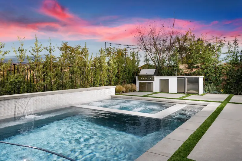 Pool and spa with tile waterfall wall at dusk — Aliso Viejo real estate photography