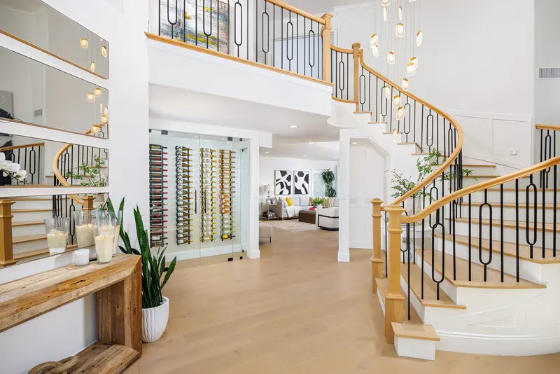 Entryway with staircase, chandelier, and built-in wine storage, Aliso Viejo