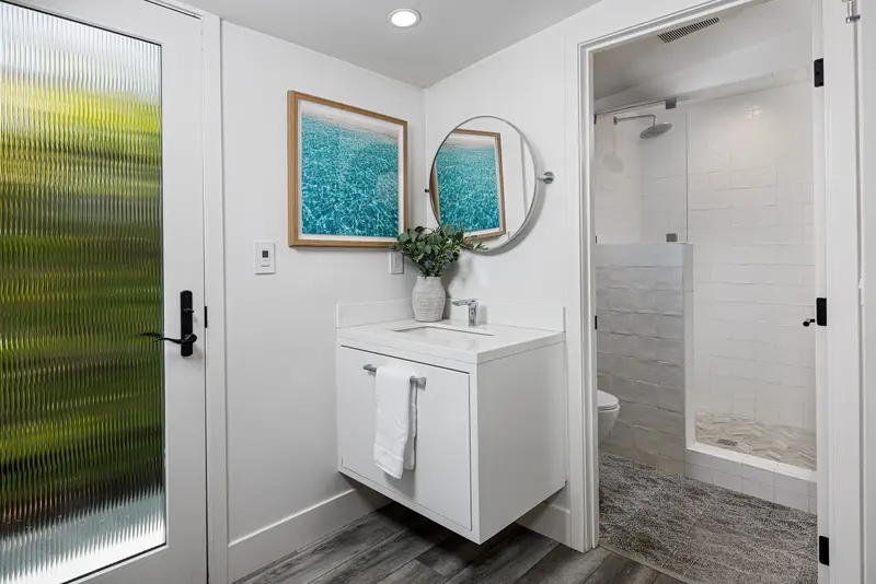Guest bathroom with coastal photography — Corona del Mar real estate photography