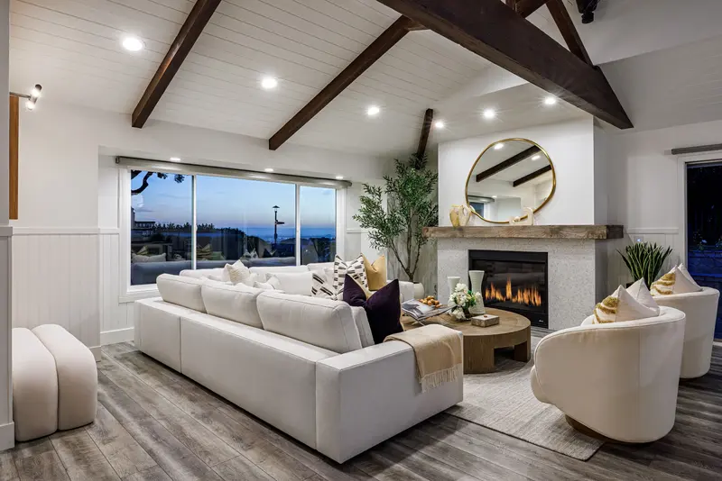 Living room at dusk with fireplace lit — Corona del Mar real estate photography