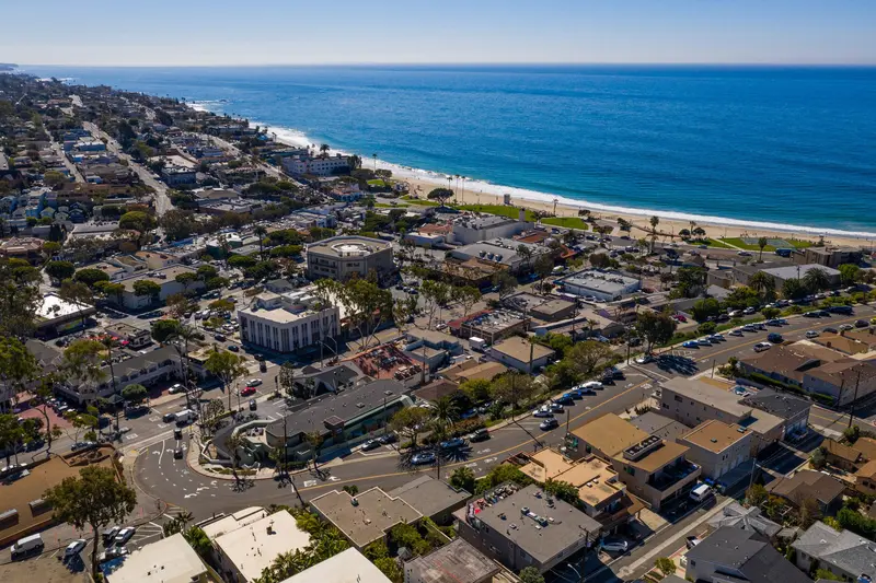 Aerial drone view looking down over downtown Laguna Beach and the shoreline
