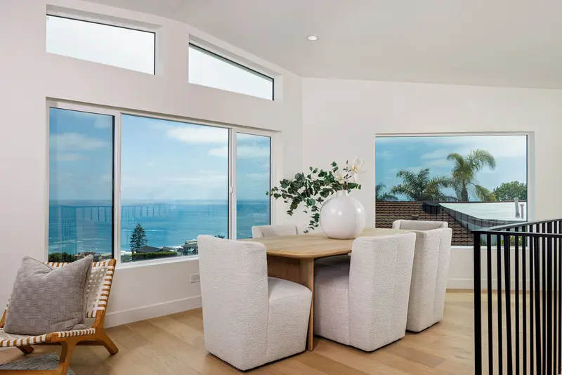 Dining room with wraparound ocean-view windows — Laguna Beach real estate photography