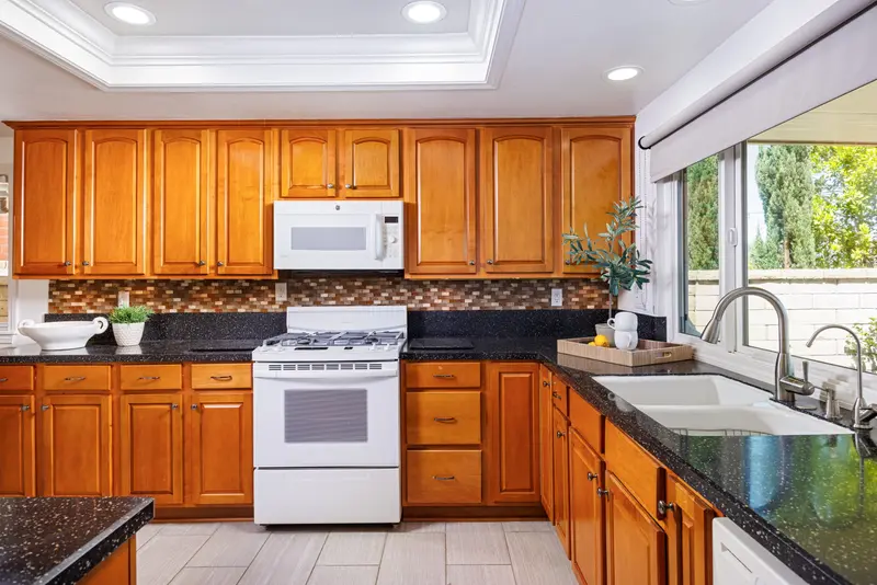 Kitchen sink with palm-tree view through the window — Mission Viejo real estate photography