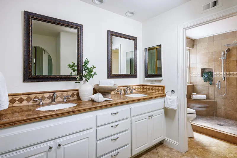 Primary bathroom dual vanity and walk-in shower — Mission Viejo real estate photography