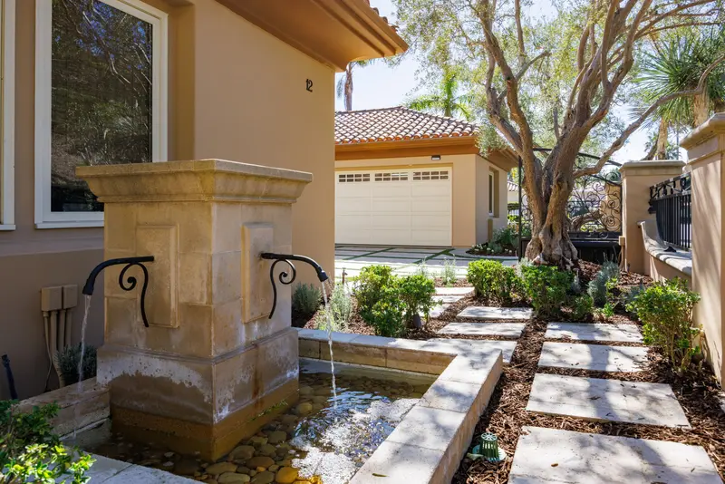 Entry courtyard fountain and stone pathway — Newport Coast real estate photography