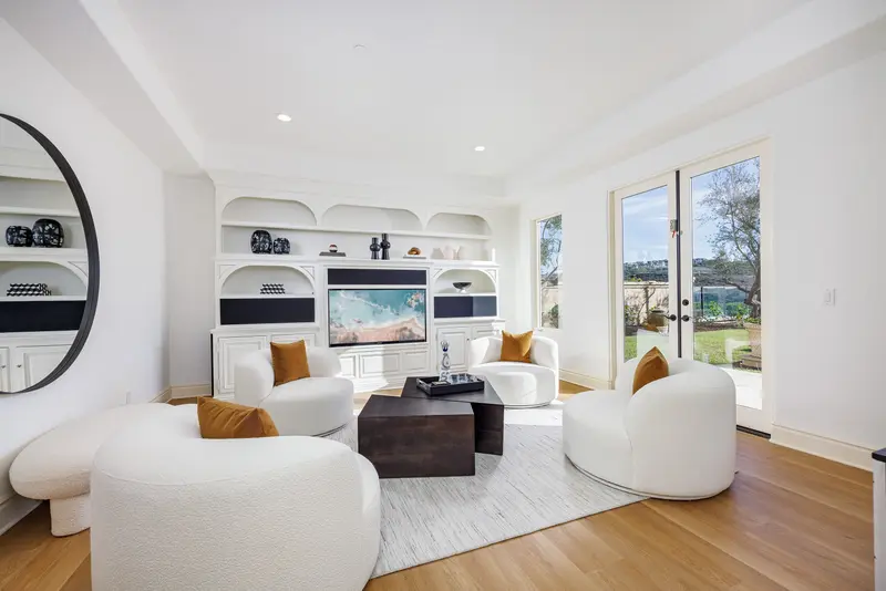 Media room seating with built-in shelving — Newport Coast real estate photography