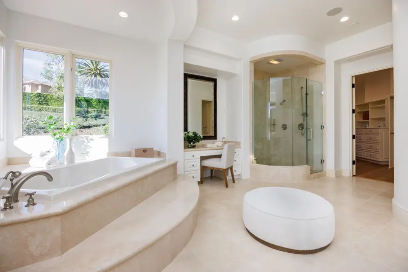 Primary bathroom soaking tub and walk-in shower — Newport Coast real estate photography