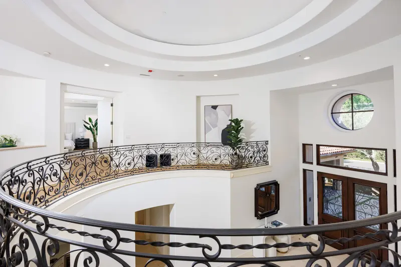 Domed rotunda staircase with wrought iron railing — Newport Coast real estate photography