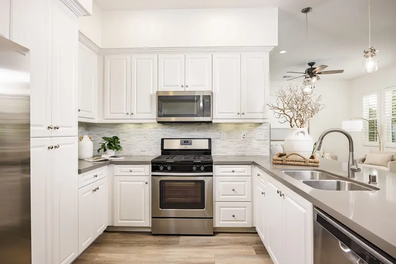 Kitchen with white cabinetry and tile backsplash — Rancho Mission Viejo real estate photography