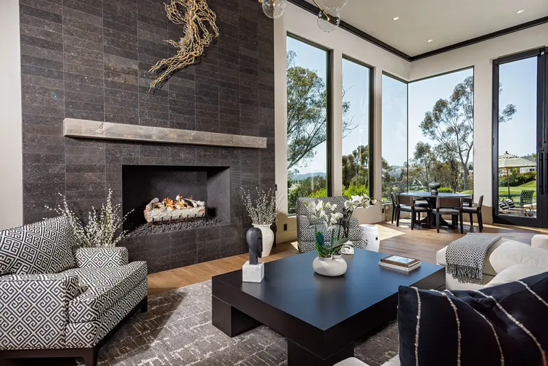 Sitting room with stone fireplace and golf course view — San Juan Capistrano real estate photography