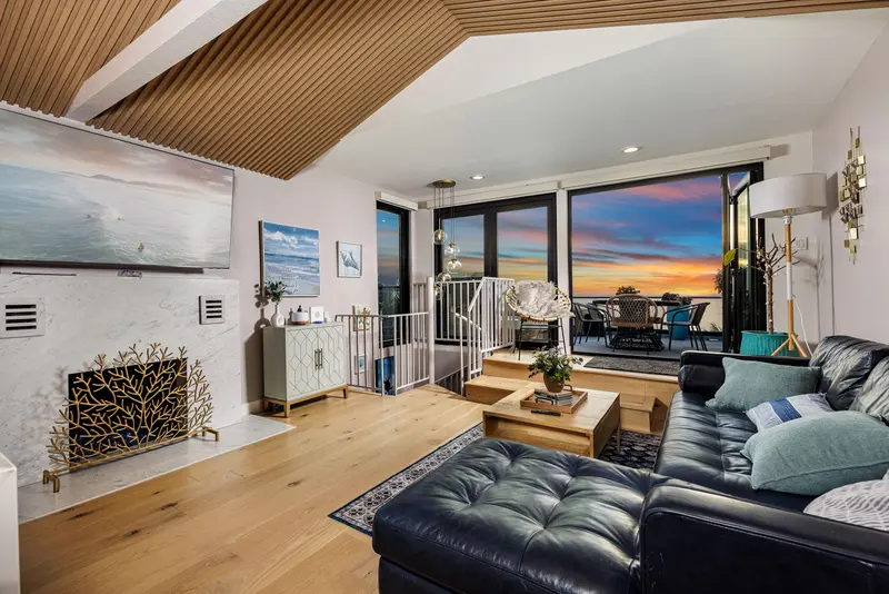 Den with leather sectional and ocean art — Laguna Beach real estate photography