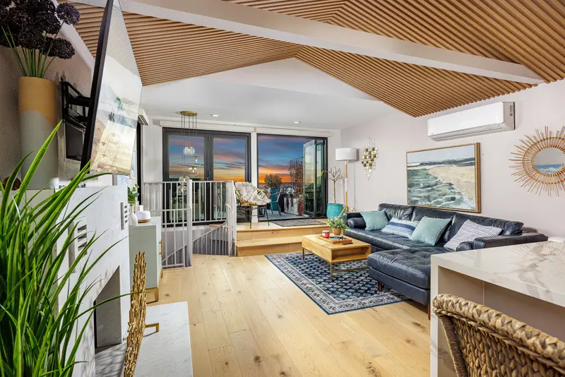 Living room with spiral staircase and sunset view — Laguna Beach real estate photography